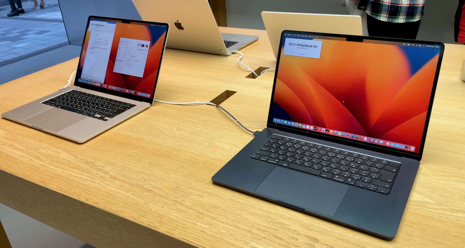 Two 15-inch MacBook Air laptops on a display table